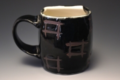 pseudo-cube black mug with inlayed aperture motif in checkered pattern