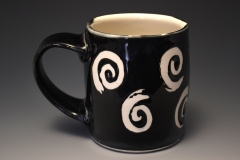 cylindrical black mug with spiral design