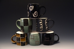 a stacked array of various mugs