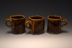 trio of pseudo-cube demitasse in amber with underglazed aperture motif