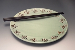 medium plate with celadon glaze and inlayed sassafras leaf in  iron oxide