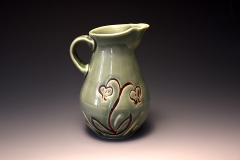 celadon pitcher with inlayed lily of the valley motif in iron oxide