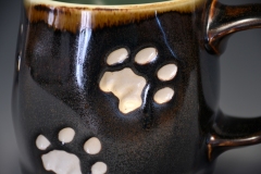 detail of cat paw print on medium mug.  starry night glaze.