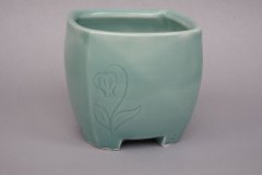 Teabowl with carved lily-of-the-valley motif: thrown then altered porcelain, celadon glaze, cone 6 oxidation.