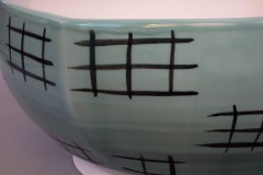 Zoom of square serving bowl showing woven motif.