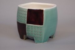 Checkered pseudocubic teabowl: thrown then altered porcelain, simple cube dot pattern  applied with slip containing  hematite crystals with a pseudocubic morphology.