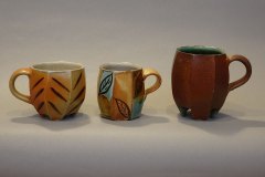 A trio of demitasse cups (from left to right): salt/ash over avery slip with shino interior; layered slips and glazes, salt/ash with Willie Helux glaze interior.