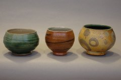 A trio of tea bowls (from left to right): Willie Helix; salt/ash over slip with shino interior; rutile over tile 6 slip with Willie Helux interior.