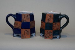 Checkered petite mugs: dense earthenware, slip flower design with cobalt (left) and copper (right) glazes.