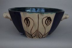 Faceted serving bowl: dense earthenware, exterior with wild flower design on rutile glaze with cobalt, copper green interior.